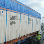 Wide load base cases stowed to flat rack for sea freight, secured and blocked in compliance with Hapag Lloyds loading criteria